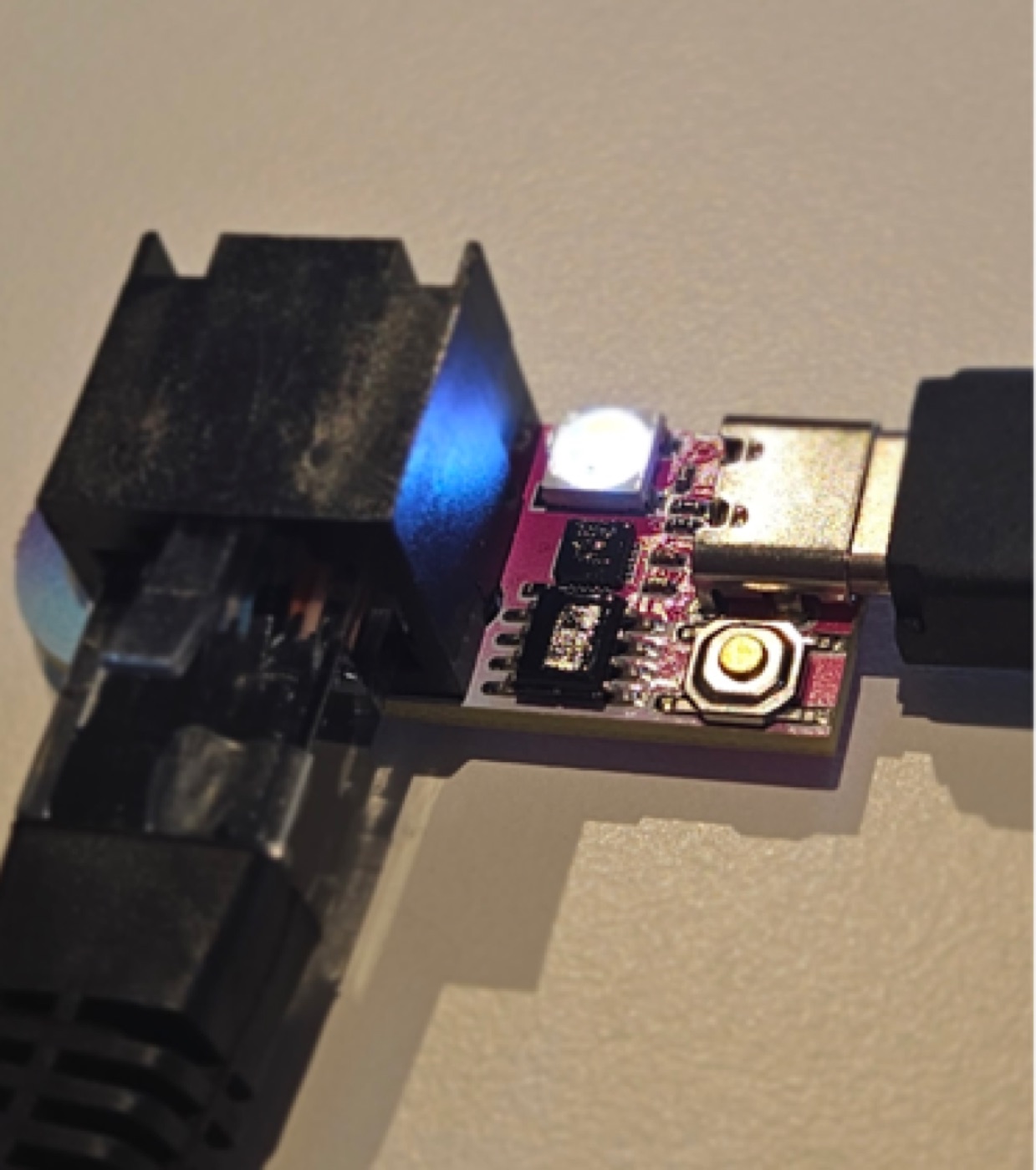 TinyDMX control button with the status LED lit blue